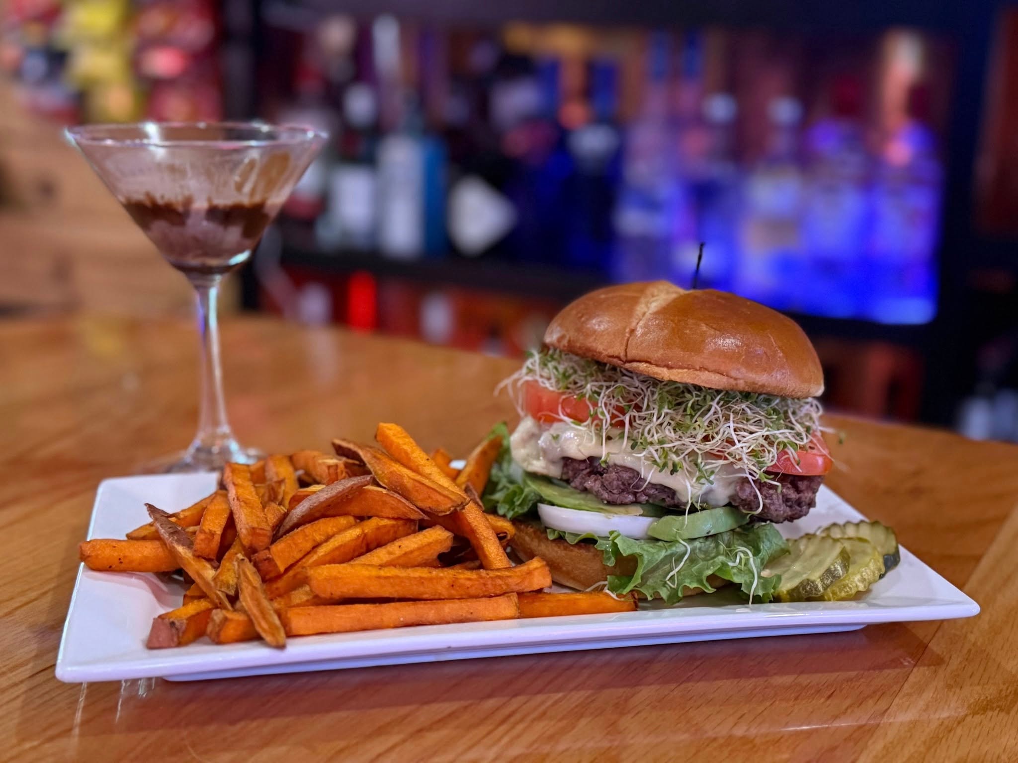 Gourmet burger with sweet potato fries and a chocolate martini