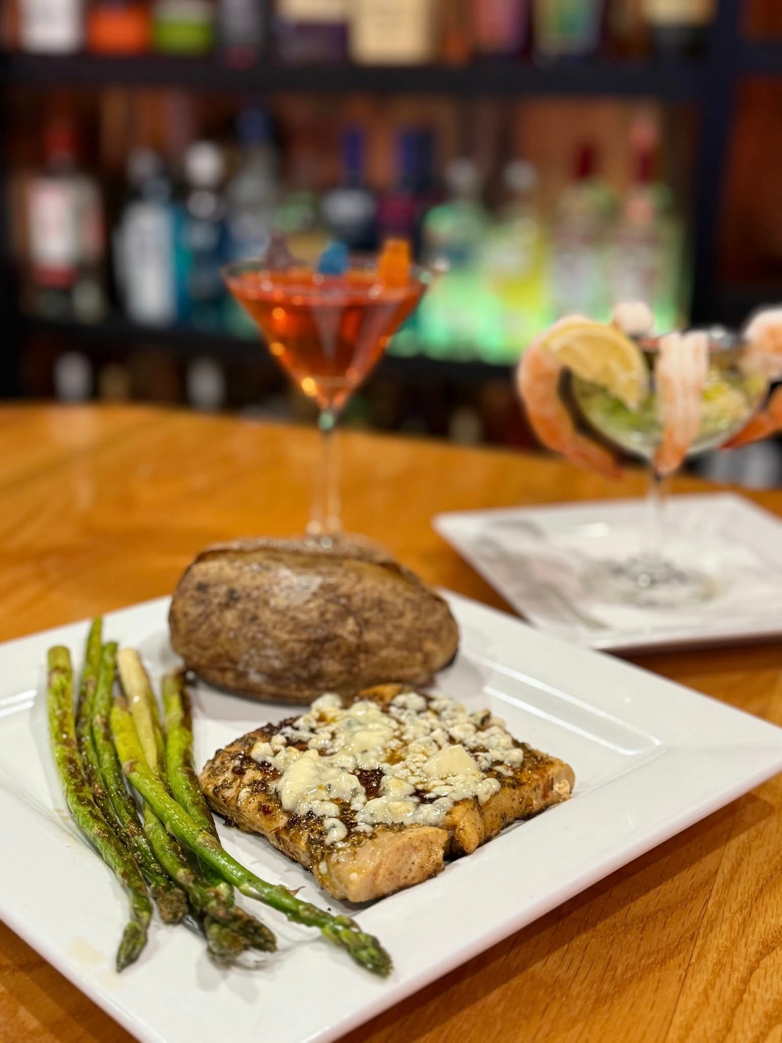 Steak with asparagus, baked potato, and specialty cocktails